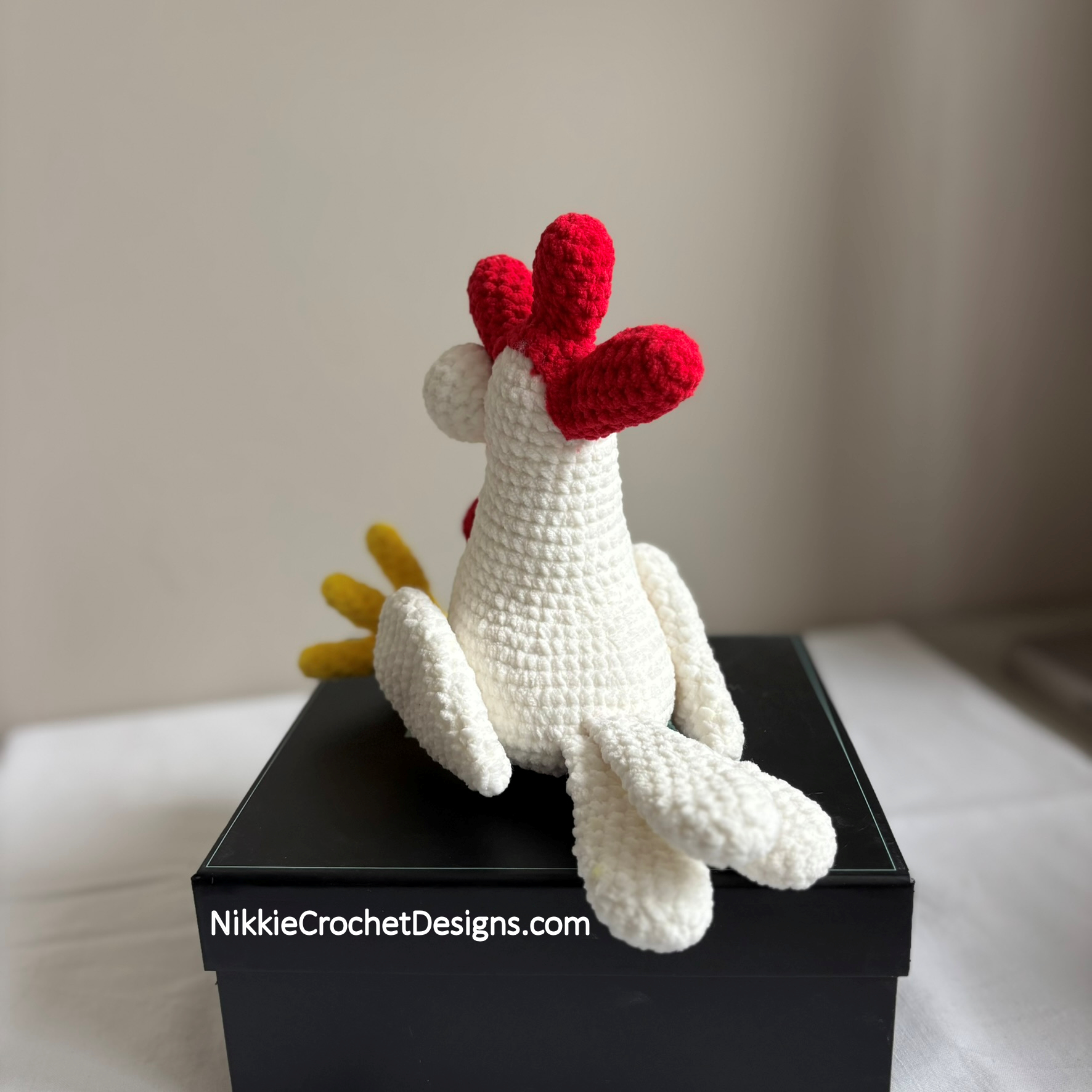 Cheeky Chicken from the side, sitting on a box